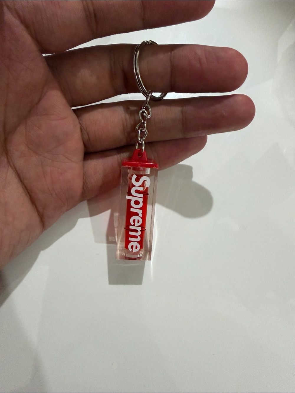 Supreme Clear Capsule Keychain with Red Accents